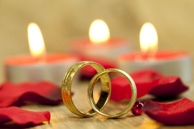 wedding rings with background beautiful red roses candles